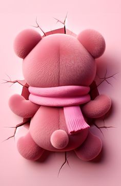 a teddy bear with a pink scarf around it's neck