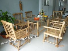 a glass table with wooden chairs around it