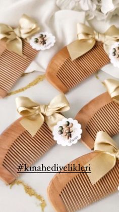 three wooden combs with bows and flowers on them