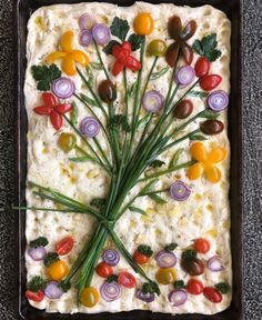 a square dish with vegetables on top of it