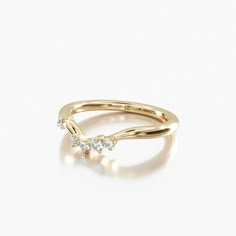 a gold ring with three diamonds on it