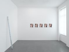 an empty room with three pictures hanging on the wall