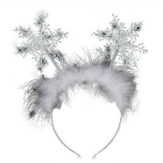 a white headband with silver flowers and feathers on top of it, against a white background