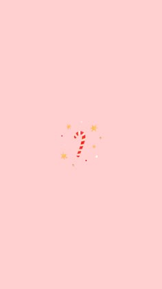 a candy cane on a pink background with stars