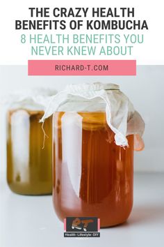 two jars filled with liquid sitting on top of a white table next to each other