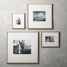 black and white photos hanging on the wall with wooden frames in front of them,