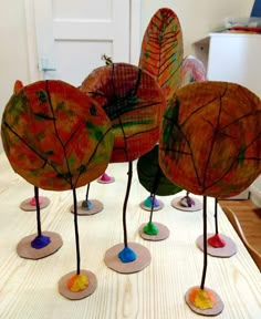 four leaf shaped sculptures sitting on top of a table