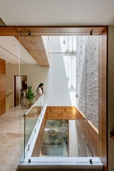 the inside of a house with glass and wood