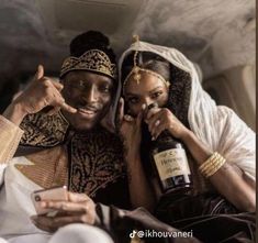 a man and woman sitting next to each other in a car with bottles on their laps