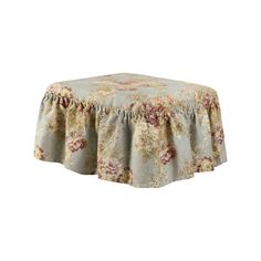 a round table with a flowered design on the top and a ruffled edge