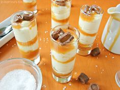 desserts are arranged on a table with salt and pepper