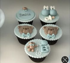 four cupcakes decorated with teddy bears and baby's first year names on them