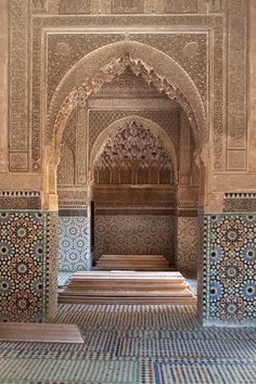 the interior of an old building with colorful tile and woodwork on it's walls