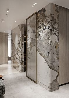 an artisticly designed room with marble walls and flooring is featured in this image