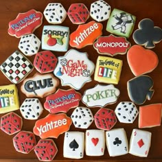 some cookies that are on top of a wooden table with cards and dice in the middle