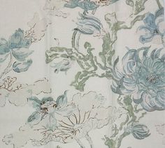 a white and blue floral fabric with flowers on it