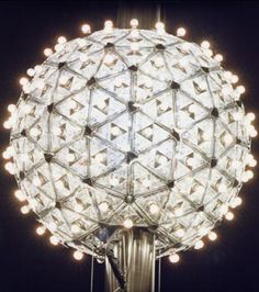 an image of a ball with lights on it and the words go to new york and watch the ball drop on new years eve