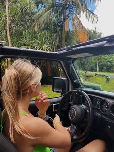 a woman sitting in the driver's seat of a truck