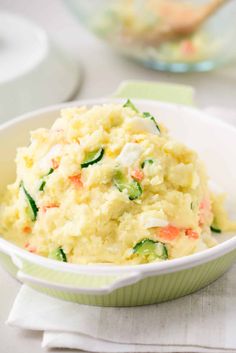 a white bowl filled with mashed potatoes and vegetables