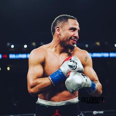 a man standing in the middle of a boxing ring