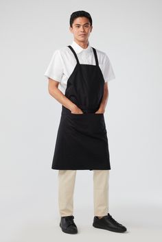 a man wearing an apron and black shoes