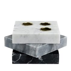 marble and brass candlesticks are stacked on top of each other