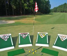 three different types of golf practice equipment on the grass with a flag in the background