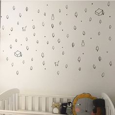 a baby's room with a crib and wall decals