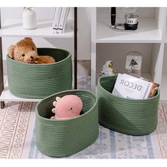 two green baskets with stuffed animals in them on a rug next to bookshelves