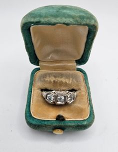 RARE Vintage Art Deco Style Stamped 14K White Gold Ladies 3-Diamond Ring! Jeweler verified natural diamonds. I believe this to be a 1920's era wedding ring or engagement ring. Features 3 quality, natural diamonds. Each diamond is approx. 3mm. Diamonds are very clear in color & clarity, I have not had them rated, but I don't see any yellow when examining them through a 30x loupe. Comes in its original, green suede, silk lined ring box, which is obviously aged, but features a working Mother of Pearl button. When pressed, the box pops open! A very similar ring is listed now for $1,295 without the original box. Ring Size: 8.25 Ring Weight: 2.32 grams Packaged carefully and shipped in original jewelry box pictured due to the historical nature. Ring is in good condition. 1920s Wedding Ring, Vintage Wedding Rings 1920s, Vintage Art Deco Engagement Ring, Bonnie Parker, 1920s Wedding, 3 Stone Rings, Nature Ring, Box Ring, Art Deco Engagement