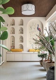 a room with white walls and plants in pots