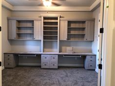 an empty room with cabinets and drawers in it