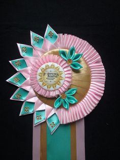 a paper plate with flowers and ribbons on it