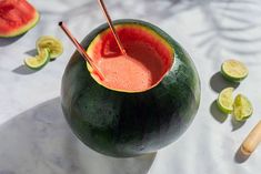 a watermelon drink with two straws in it