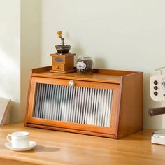 an old fashioned radio sitting on top of a wooden table next to a coffee maker