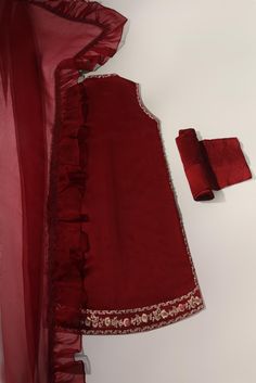 Canvassed on a jewel pomegranate tone of deep maroon in pure raw silk 58 Gms heavily embellished with embroidery details alongside hand/ada work, styled with matching trousers and pure frilly organza dupatta. Turns heads in this beautiful design. The length of the open shirt is 40 inches. Order Duration: 4 to 6 weeks Dabka Detailed Raw Silk Sharara For Party Wear, Raw Silk Party Wear Sets With Dabka Detail, Party Wear Raw Silk Sets With Dabka, Designer Organza Palazzo Set For Party, Raw Silk Party Wear Sets With Dabka, Fashionable Organza Palazzo Set For Party, Silk Anarkali Set With Dupatta For Party Wear, Organza Palazzo Set With Intricate Embroidery For Party, Fitted Organza Sharara With Dabka Detail