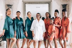 a group of women standing next to each other in robes and shoes, posing for a photo