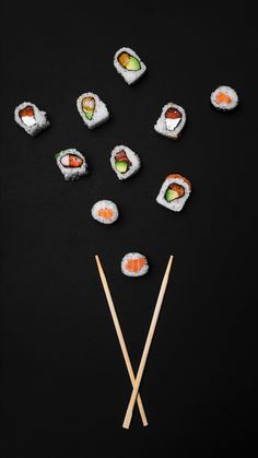 Crossed sushi sticks with sushi pieces all over the top over a black background Komodo Miami, Sushi Branding, Japanese Sushi Restaurant, Sushi Style, Photoshoot Creative, Sushi Time, Sushi Art