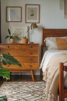 a bed room with a neatly made bed next to a wooden dresser and potted plants