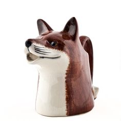 a ceramic fox head on a white background