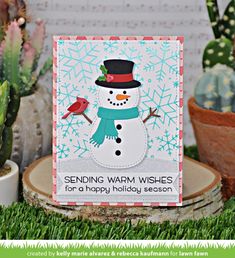 a card with a snowman and a bird on it in front of cacti