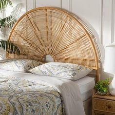 a wicker headboard on a bed in a room with white walls and flooring