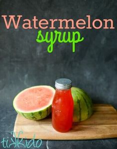 watermelon syrup in a glass bottle next to a melon on a cutting board