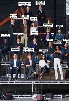 a group of people standing on top of a stage with names in front of them