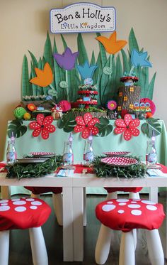 the table is set up with red and white stools for children's birthday party