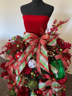 a mannequin dressed in red and green christmas decorations