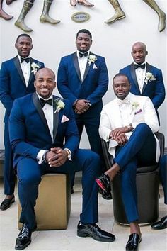 a group of men in suits posing for a photo