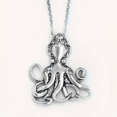 an octopus necklace is shown on a white background and it has silver colored metal accents