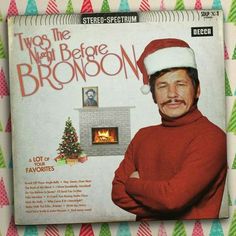 an album cover with a man wearing a santa hat and holding his arms crossed in front of a fireplace