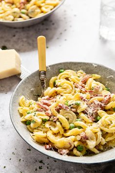 a bowl of pasta with peas and ham